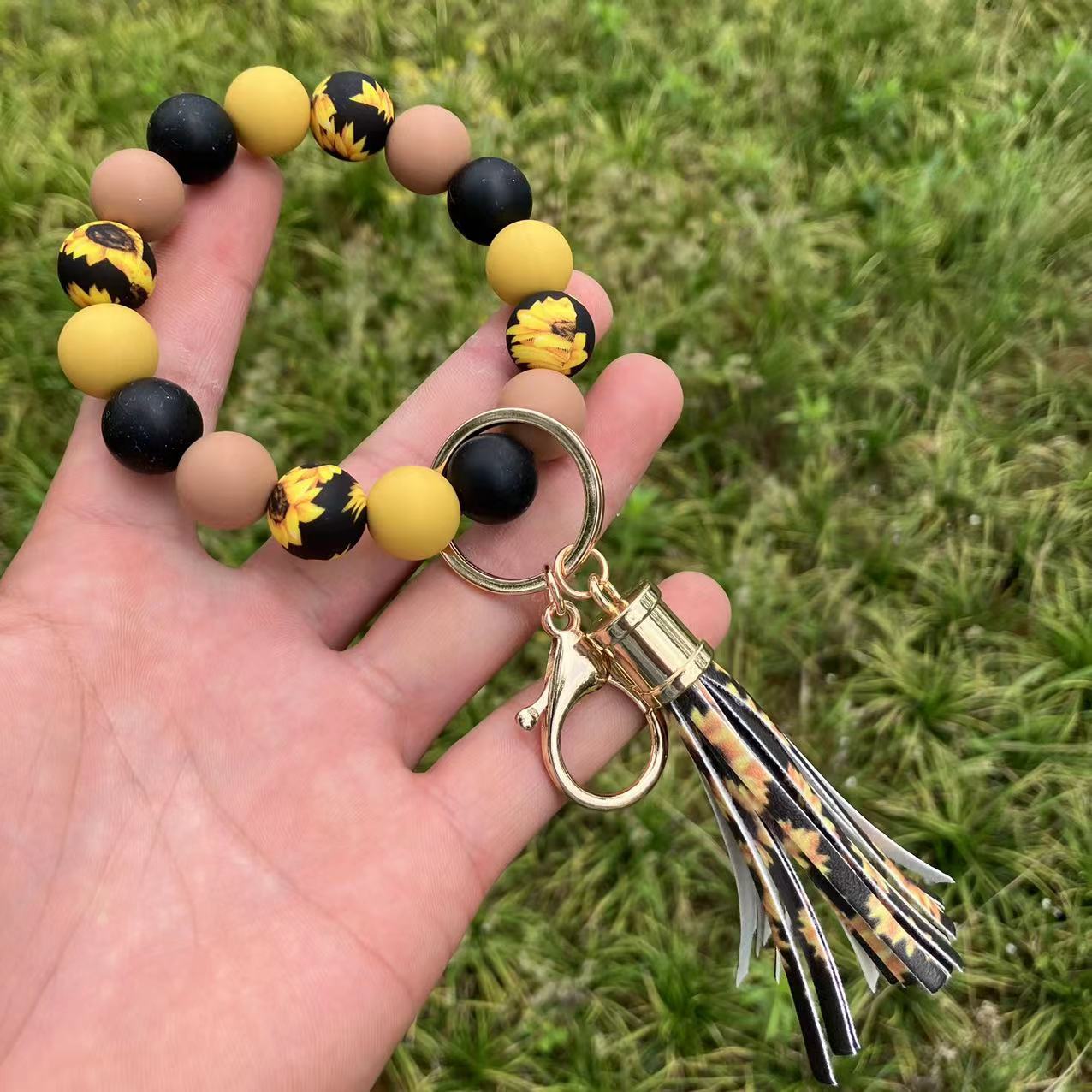 Comercio al por mayor leopardo girasol borla de silicona con cuentas llavero de muñeca